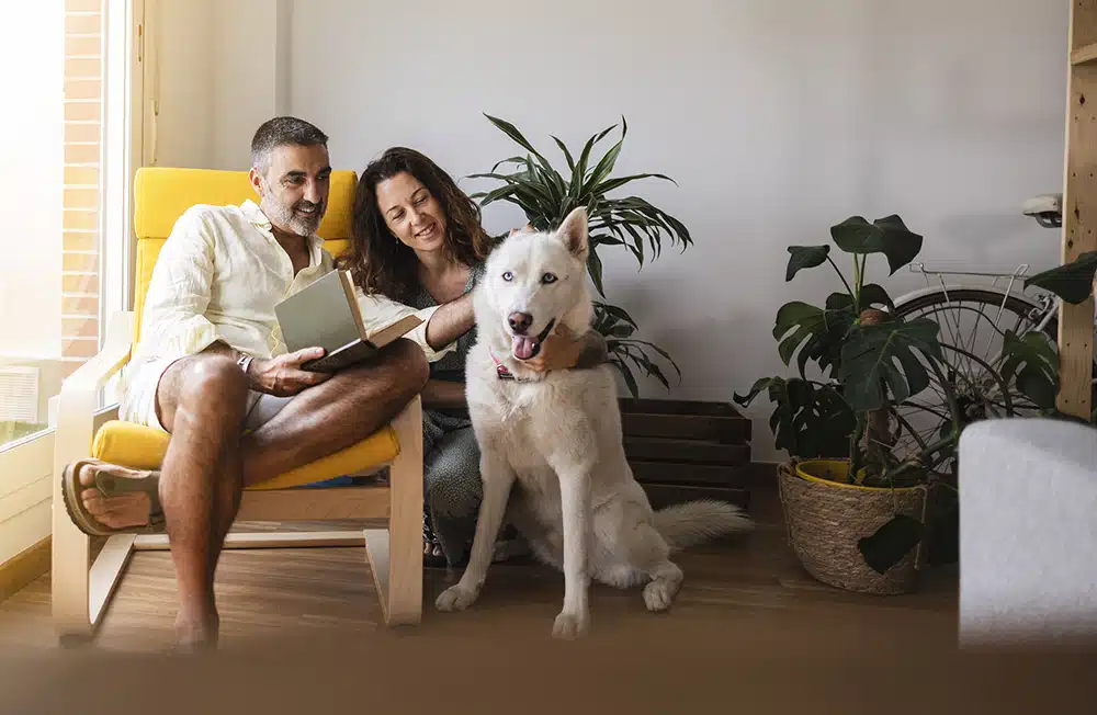 Happy family with dog in home in Franklin Lakes, NJ.