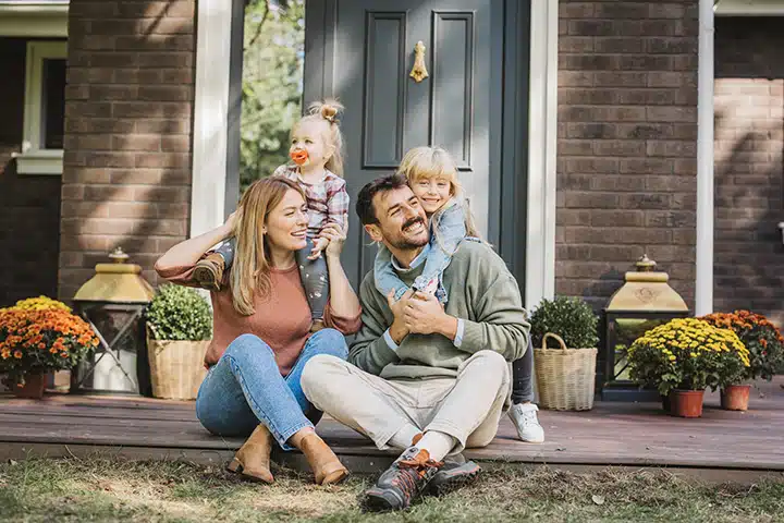 Happy family sitting on front porch in Franklin Lakes NJ